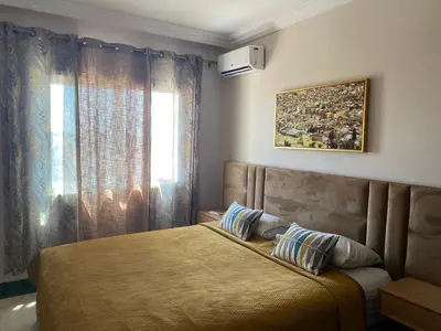a bedroom with a bed and a window at appartement en plein centre de casablanca in Casablanca