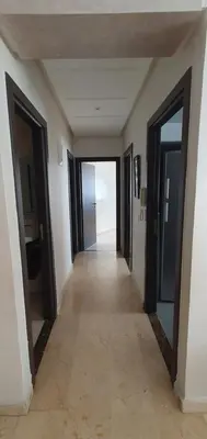 a hallway in a house with doors open at Chaleureux Appartement à 1 min à pied de la Mosquée Hassan II in Casablanca