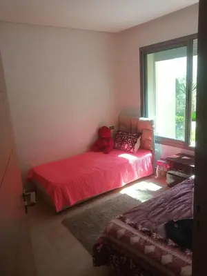 a bedroom with a bed with a teddy bear on it at Apparemment Rockisland in Mohammedia