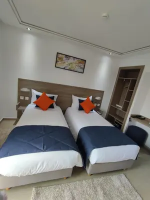 two beds sitting next to each other in a bedroom at LOTUS HOTEL Casanearshore in Casablanca