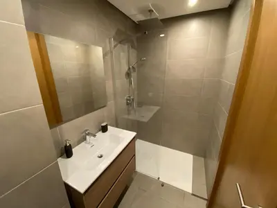a white bathroom with a sink and a shower at La casa in Casablanca