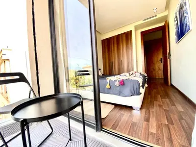 a room with a bed and a table and a window at NEW modern 1 BR, 1min fr tramway in Casablanca