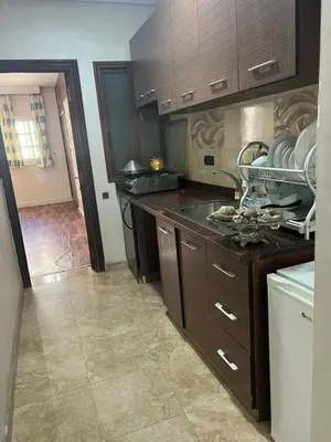 a kitchen with a sink and a counter top at Résidence Faouazi in Casablanca