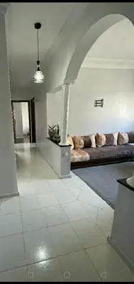a living room with a large couch in a room at Appartement à peu près 10 mn de la plage et une demie heur verre le stade dhonneur in Casablanca
