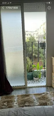 an open sliding glass door with potted plants outside at Appartement à peu près 10 mn de la plage et une demie heur verre le stade dhonneur in Casablanca