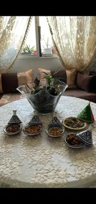 a table with plates of food on a table at Appartement à peu près 10 mn de la plage et une demie heur verre le stade dhonneur in Casablanca