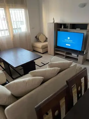 a living room with a couch and a tv at Cozy place in the heart of rabat in Rabat