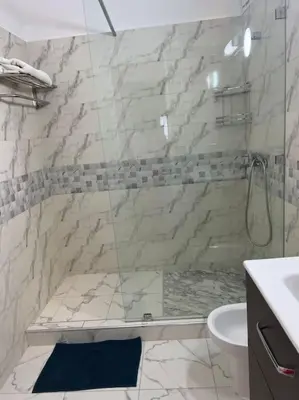 a bathroom with a shower and a toilet and a sink at Cozy place in the heart of rabat in Rabat