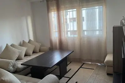 a living room with a couch and a table at Cozy place in the heart of rabat in Rabat