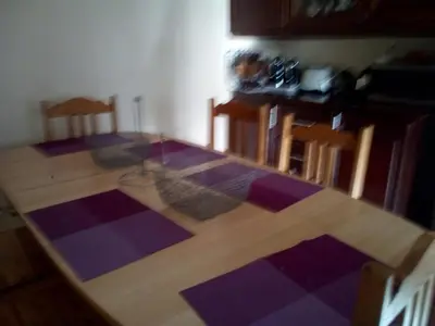 a kitchen with a wooden table and a purple floor at Bel appartement quartier Bourgogne in Casablanca
