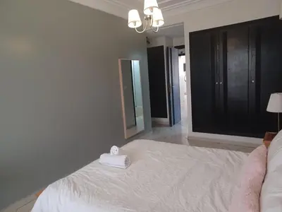 a bedroom with a bed with a towel on it at Grand appartement lumineux avec balcon & parking idéal familles et pro in Casablanca