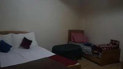 a small bedroom with a bed and a chair at Auberges Des Jeunes Casablanca in Casablanca