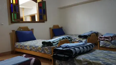 a room with two beds and a mirror at Auberges Des Jeunes Casablanca in Casablanca