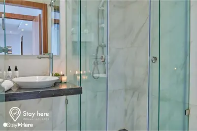 a bathroom with a sink and a glass shower at Stayhere Rabat - Hay Riad - Sophisticated Residence in Rabat