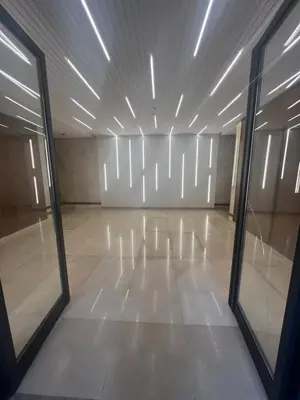 a large empty room with a reflection of a building at Luxurious Appartement at Casa Finance City in Casablanca