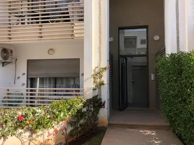 a front door of a building with a balcony at Charmant studio lumineux Casablanca in Bouskoura