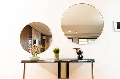 a mirror on the wall in a bathroom with a table at Casablanca Marina Ocean View - By AppartAli in Casablanca