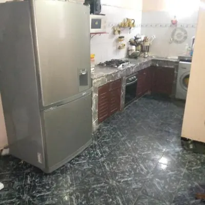 a kitchen with a stainless steel refrigerator at Spacious bedrooms in a traditional house in Rabat