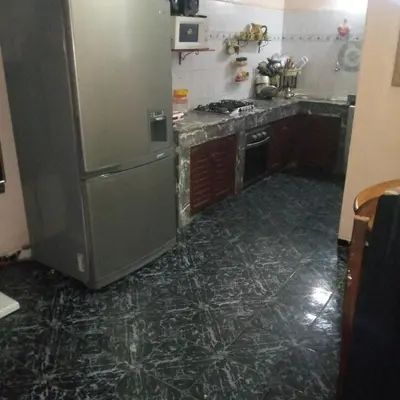 a kitchen with a stainless steel refrigerator in it at Spacious bedrooms in a traditional house in Rabat
