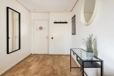 a hallway with a glass table and a white door at TT Holidays-Rabat City Center in Rabat