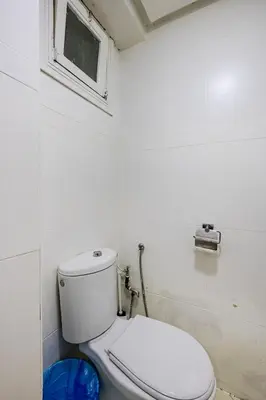 a white toilet in a bathroom with a window at TT Holidays-Rabat City Center in Rabat