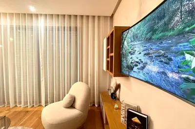 a living room with a large flat screen tv on a wall at The Panorama of Marina - AppartAli in Casablanca