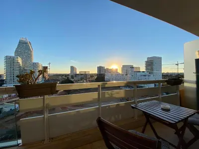 a balcony with a table and a view of the city at Faubourgs Anfa Top Floor By AppartAli in Casablanca