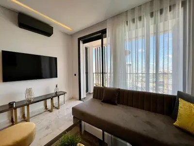 a living room with a couch and a large window at Anfa 212 Top Floor - 2 Bedrooms- By AppartAli in Casablanca