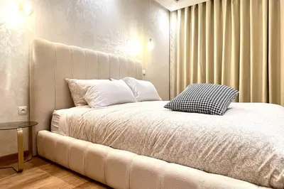 a bedroom with a large bed with white sheets and pillows at The Suite of Artists - Central - By AppartAli in Casablanca