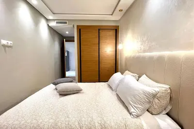 a bedroom with a large bed with pillows on it at The Suite of Artists - Central - By AppartAli in Casablanca