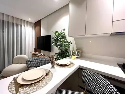 a kitchen with a counter with chairs and a table at Presidential Suite City Center by AppartAli in Casablanca