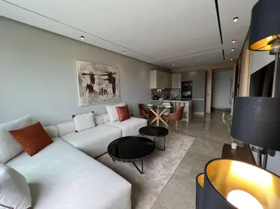 a living room with a white couch and a table at Royal Suite by the Ocean - By Appartali in Casablanca