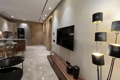 a living room with a television on a wall at Royal Suite by the Ocean - By Appartali in Casablanca