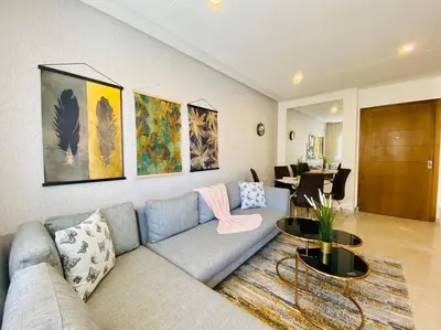 a living room with a couch and a table at Cosy Triangle D Or Bourgogne - By AppartAli in Casablanca