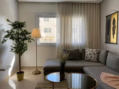 a living room with a couch and a table at Cosy Triangle D Or Bourgogne - By AppartAli in Casablanca