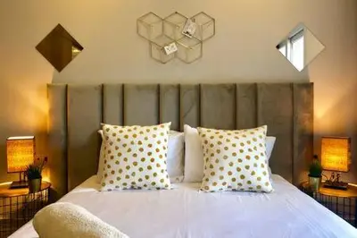 a bedroom with a large white bed with pillows at Triangle D Or Bourgogne - By AppartAli in Casablanca