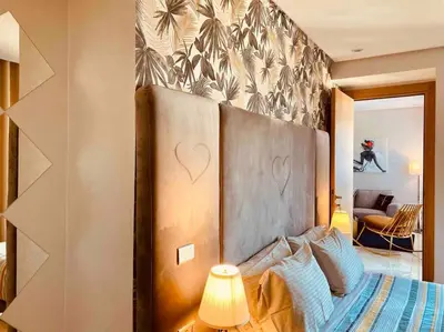 a bedroom with a bed with a heart on the wall at Mogador Presidential Terrace - By AppartAli in Casablanca