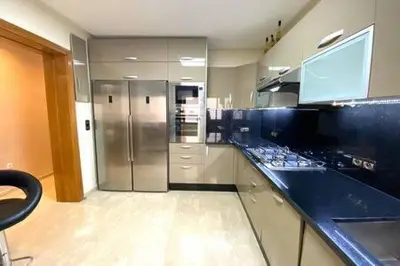 a kitchen with a blue counter top and a refrigerator at Familial Boulevard D Anfa - By AppartAli in Casablanca
