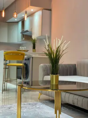 a living room with a table and yellow chairs at Charming Top Floor Bourgogne - By AppartAli in Casablanca