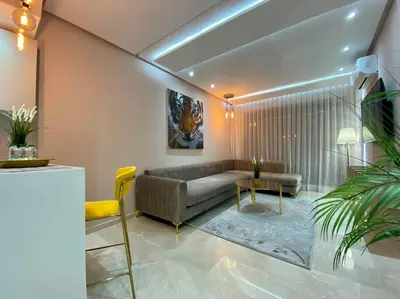 a living room with a couch and a table at Charming Top Floor Bourgogne - By AppartAli in Casablanca