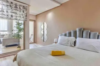 a bedroom with a large bed with a yellow object on it at Contemporary Top Floor Bourgogne - By AppartAli in Casablanca