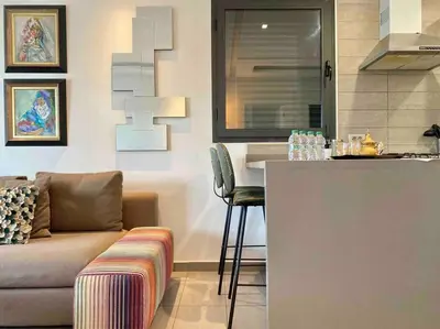 a kitchen with a couch and a bar in a room at Faubourgs D Anfa Suite - By AppartAli in Casablanca