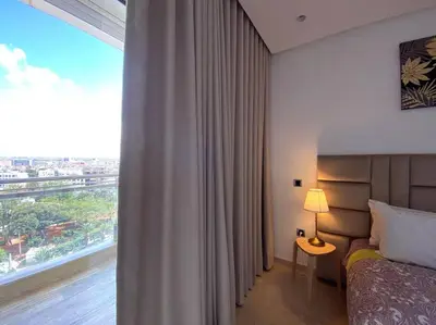 a hotel room with a bed and a large window at Maarif City Sunrise- 3 Beds - By AppartAli in Casablanca