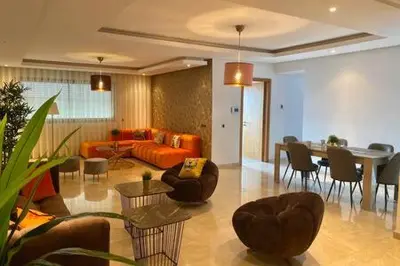 a living room with a couch and a table and chairs at Maarif Sunset View - 3 Bedrooms - By AppartAli in Casablanca