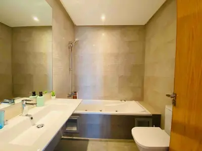 a bathroom with a tub and a sink and a toilet at Maarif Top Floor - 2 Bedrooms - By AppartAli in Casablanca