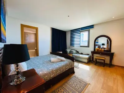 a bedroom with a bed and a living room with a desk at The view - Marina 2 Beds - By AppartAli in Casablanca