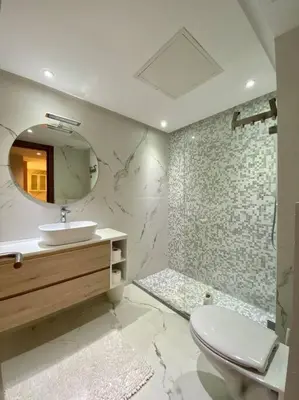 a bathroom with a toilet and a sink and a mirror at Deluxe Princesses Design - By AppartAli in Casablanca