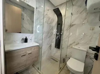 a bathroom with a shower and a toilet and a sink at Modern Cosy Studio Anfa in Casablanca