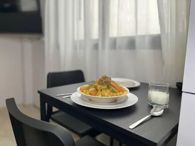 a table with a plate of food and a glass of milk at Modern Cosy Studio Anfa in Casablanca