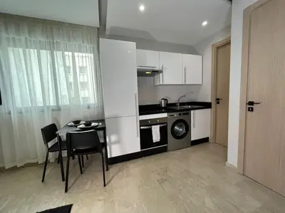 a small kitchen with a table and a stove at Modern Cosy Studio Anfa in Casablanca